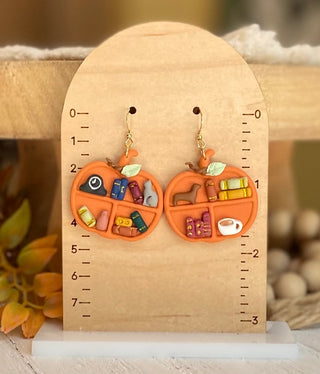 Bookish pumpkin earrings with colorful books and a cozy coffee cup