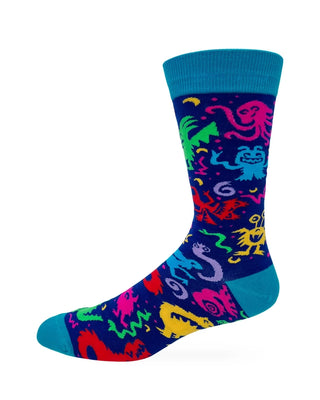 Side view of deep blue crew sock with bright multicolored monsters and teal cuff, heel, and toe