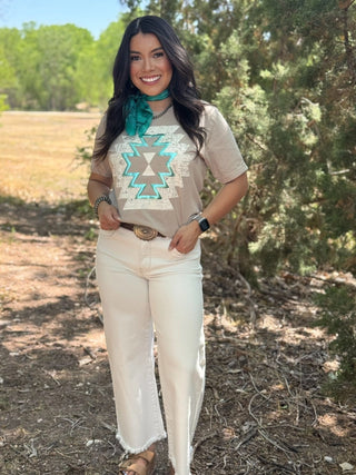 Neutral Bella+Canvas tee with ivory Aztec graphic and teal metallic puff detail