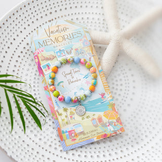 Jilzarah Vacation Memories beaded bracelet on display card with palm leaf and white rope styling