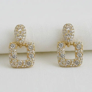 Gold pavé CZ geometric drop earrings - front view on white linen background