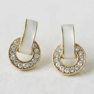 White enamel bar and crystal pavé horseshoe drop earrings gold tone - close-up front view