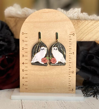 Halloween owl earrings with white owls, leafy branches, and floral accents