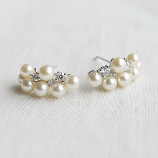 Pearl and crystal cluster hoop earrings - front view on soft white linen background