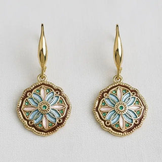 Vintage enamel mandala medallion dangle earrings - front view on white linen background