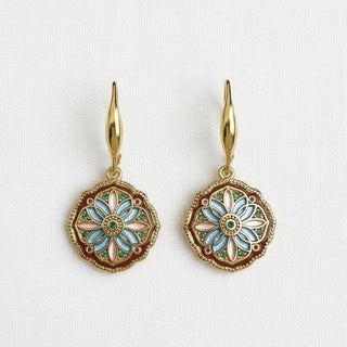 Vintage enamel mandala medallion dangle earrings - straight-on view on white linen background